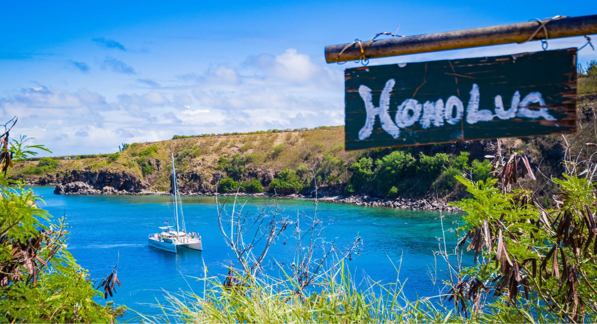 A catamaran anchored in Honolua Bay, Maui, on a calm September morning, a Marine Life Conservation District known for exceptional snorkeling visibility